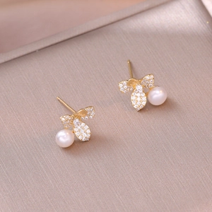 Elegant gold bee earrings with sparkling cubic zirconia wings and hanging white pearls