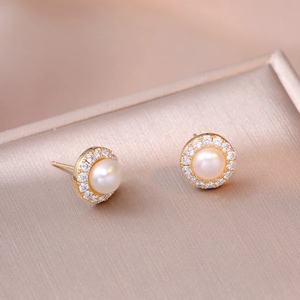 Vintage gold halo earrings featuring natural freshwater pearls and sparkling zircon accents