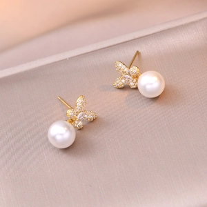 Elegant gold bow earrings with sparkling crystals and round white pearls for women