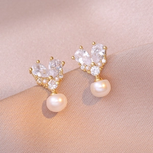 Elegant vintage heart earrings with freshwater pearls and zircon on champagne silk background
