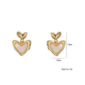 Macro detail of vintage heart stud earrings with dimensions 13mm by 10mm and pearl finish