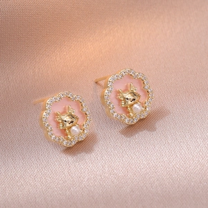 Pink enamel flower earrings with golden dragon, pearls and crystals on silk background