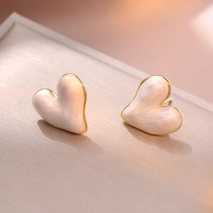 Minimalist pearl white heart stud earrings with golden metallic edges for women