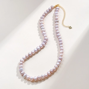 Detail of lavender freshwater pearls with S925 sterling silver gold clasp and heart tag