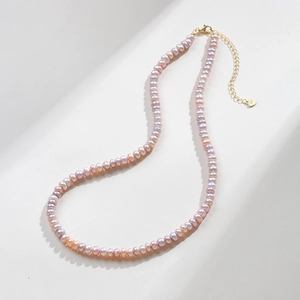 Close-up of S925 silver stamp on heart pendant with natural lavender pearl necklace