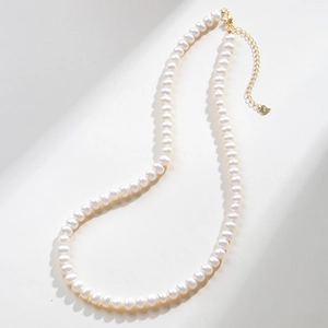 Detailed macro of S925 silver clasp and heart pendant on freshwater pearl necklace