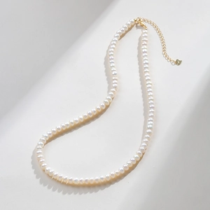Detail of freshwater pearl necklace showing S925 sterling silver heart charm and clasp
