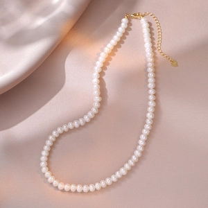 Detail of S925 sterling silver lobster clasp and heart tag on freshwater pearl necklace