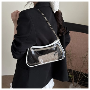 Detailed shot of transparent PVC baguette bag with white leather trim and gold chain