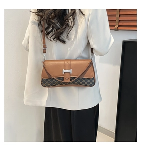 Detail view of vintage patchwork shoulder bag with leather trim and monogram pattern