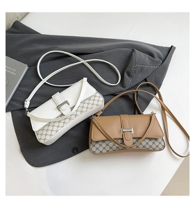 Detail of vintage crossbody bags with brown pattern stitching and silver metal buckle