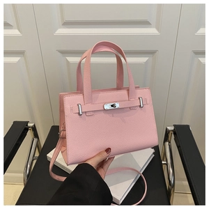 Detail of pink lychee grain leather bag with silver metal swivel lock and strap closure