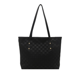 Classic black quilted tote bag with golden metal rivets and sleek minimalist design