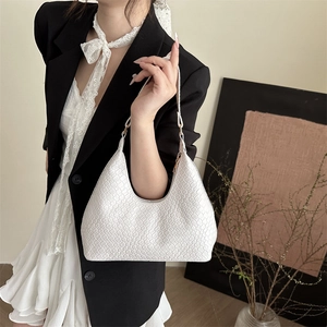 Elegant white patent leather hobo bag featuring woven texture and gold metal accents