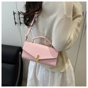 Pink leather shoulder bag detail with embossed squares and golden musical note clasp