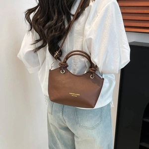 Brown litchi leather tote bag with top handles and adjustable strap in Korean style