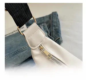 Detail of premium golden metal zipper and smooth stitching on cream dumpling bag