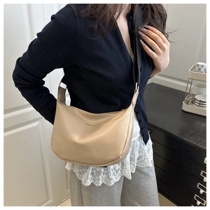 Crossbody crescent bag in beige PU leather with wide black strap and fashion text detail