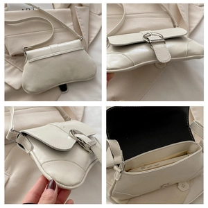 Detail view of cream saddle bag with silver buckle showing interior space for phone
