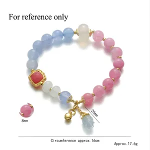 Floral beaded bracelet with colorful stones, bell charm, and golden flower petal accents