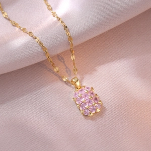 Elegant gold titanium steel necklace with a rectangular pink zircon pendant on silk background
