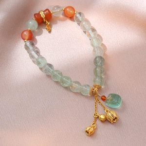 Green fluorite beaded bracelet with vintage bells and floral charms in gold finish