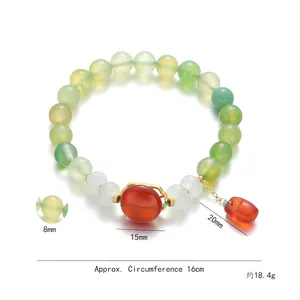 Beaded green agate bracelet with red flower charm and dimensions on white background