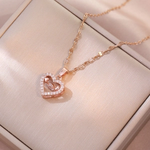 Elegant rose gold heart pendant necklace featuring shimmering crystals and a moving stone
