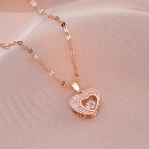 Detailed view of rose gold heart pendant necklace with shimmering zircon accents