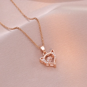 Rose gold cat-ear heart necklace with dancing diamond pendant on pink silk