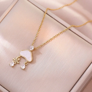 Elegant gold cloud and snowflake necklace with teardrop zircons on a champagne velvet box
