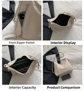 Detail view of beige crescent tote bag showing interior capacity and front zip pocket