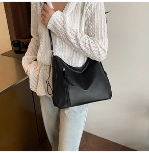 Detail shot of black leather Hobo bag with vertical zipper and adjustable strap