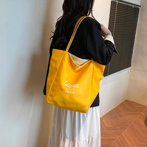 Large capacity bright yellow nylon tote bag for women showing a stylish casual design