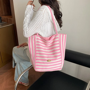 Pink and white striped canvas tote bag shown with model for daily casual style