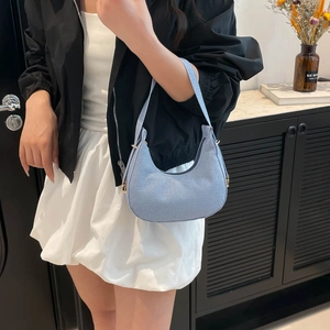 Minimalist light blue denim crescent shoulder bag with golden metallic buckles for women