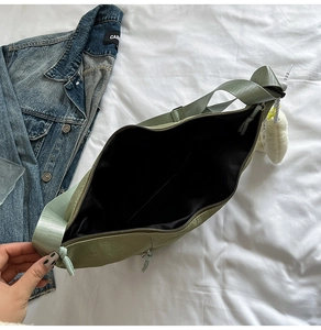 Interior view of sage green hobo bag showing spacious black lining and zip closure
