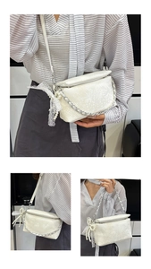 Detail of white snake pattern shoulder bag with pearl accents and silver chain strap