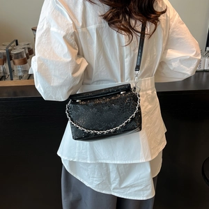 Black snake-embossed square crossbody bag with silver chain and leather strap details