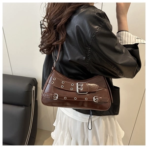 Detail of dark brown retro motorcycle underarm bag with silver grommets and buckles