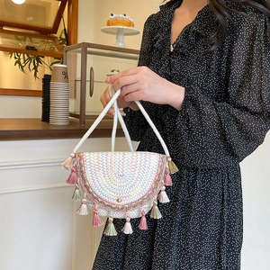 Bohemian zigzag woven crossbody bag with colorful tassels and a white cotton rope handle