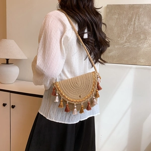 Bohemian straw woven crossbody bag with colorful tassels and ethnic embroidery details