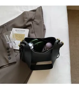 Interior view showing the large capacity of the black minimalist leather bucket bag