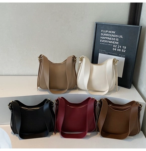 Multi-color collection of smooth PU leather tote bags on a minimalist step display