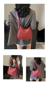 Detail view of burgundy tote bag showing wide shoulder strap and side tassel drawstring