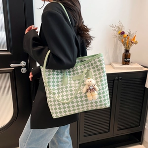 Green and white checkerboard tote bag with shoulder straps and cute bear pendant