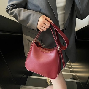 Elegant burgundy leather tote bag for women featuring a minimalist soft bucket design
