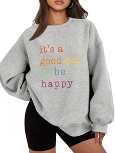 Close-up of grey sweatshirt with colorful It’s a good day to be happy slogan print
