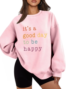 Detailed close-up of pink crewneck sweatshirt with it's a good day to be happy letter print