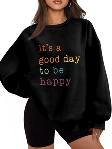 Detail of black fleece sweatshirt with 'it's a good day to be happy' colorful slogan